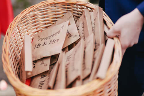 Person holding a basket full of wedding favors