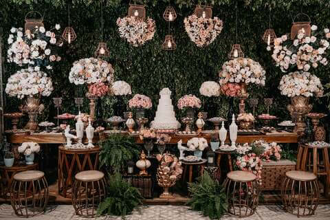 Dessert display with flowers in classic vases and candles