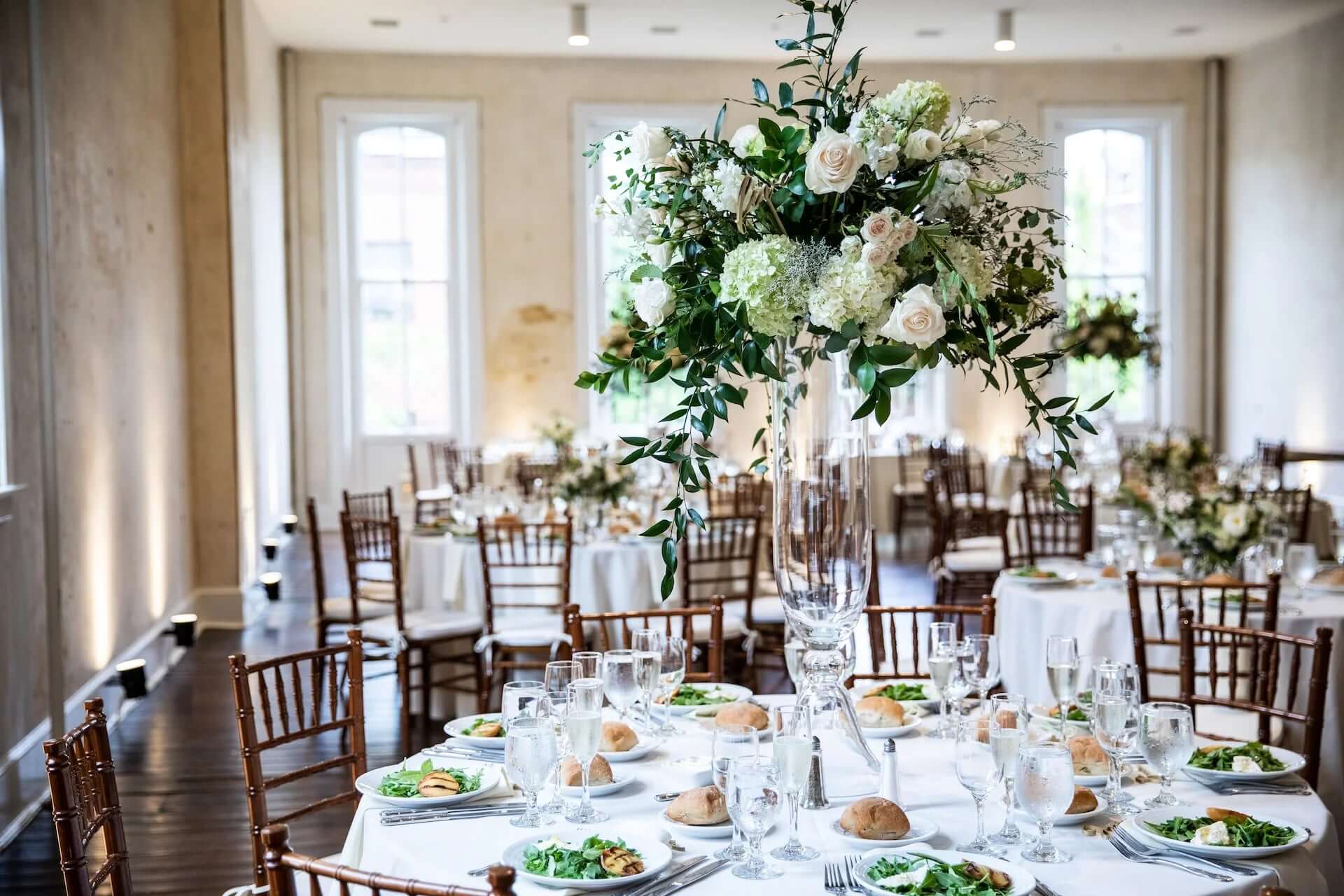 Formal wedding table with tall white flower centerpieces
