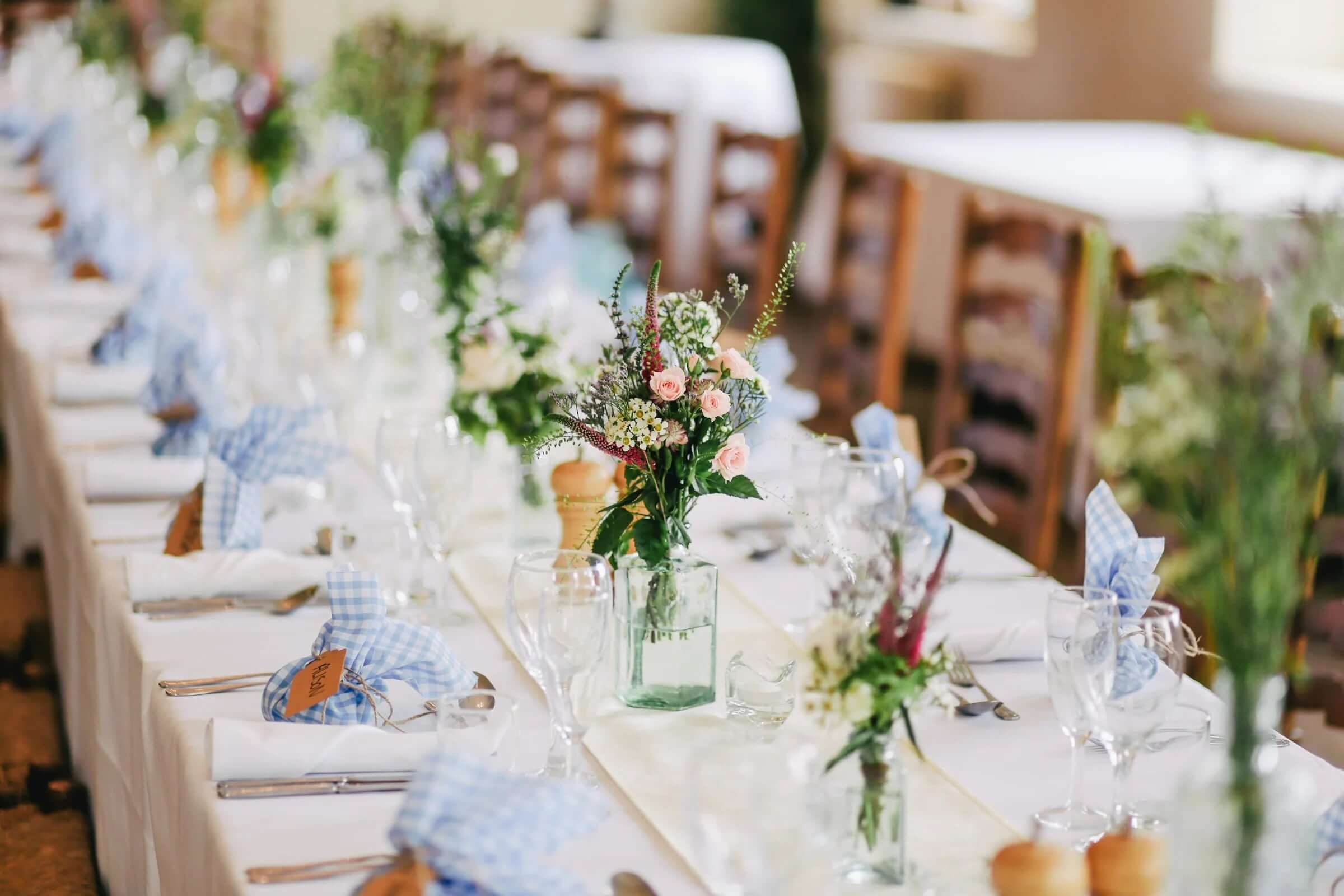Summer flowers in a clear vase as a table centerpiece