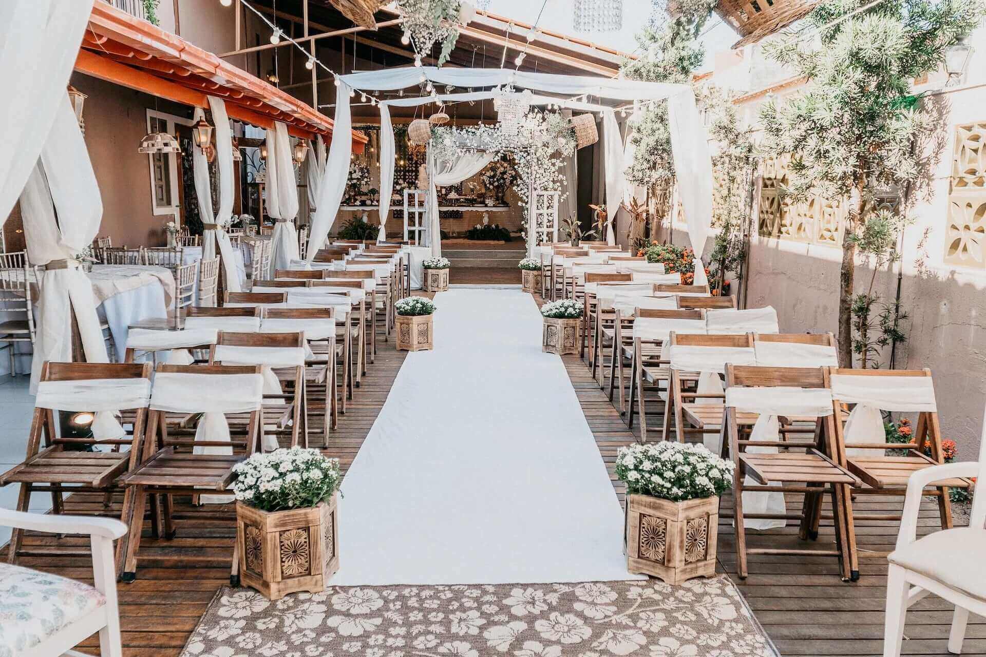 Outdoor wedding ceremony with white carpet
